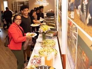 Attendees enjoying food at the event.