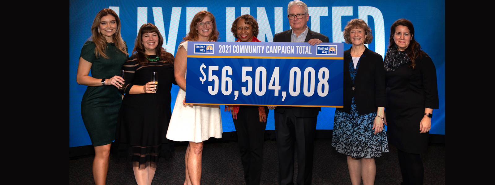 image of community leaders with $56,504,008 sign