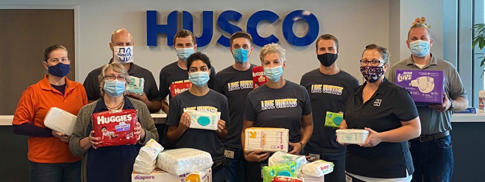 group of Husco employees at a diaper collection drive during their workplace campaign