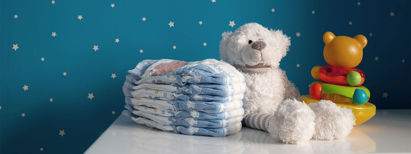 image of diapers and teddy bear on changing table