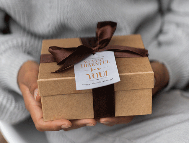 Image of hands holding a wrapped gift. Image of hands holding a wrapped gift. 