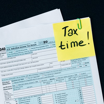 Tax paperwork with a sticky note that says Tax Time
