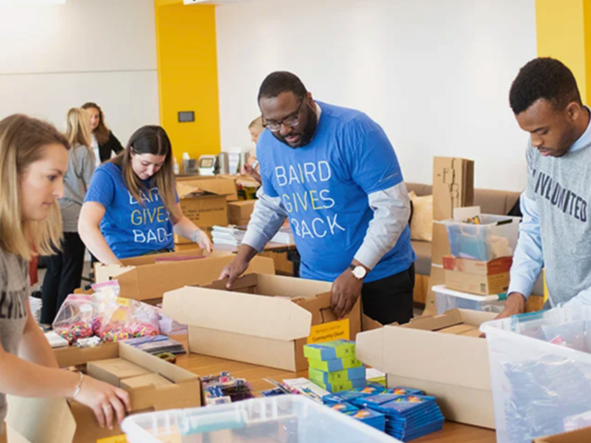 Baird associates participate in a kit-packing with United Way.
