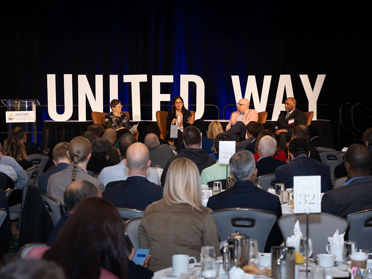image of United Way letter with panel of four people on event stage