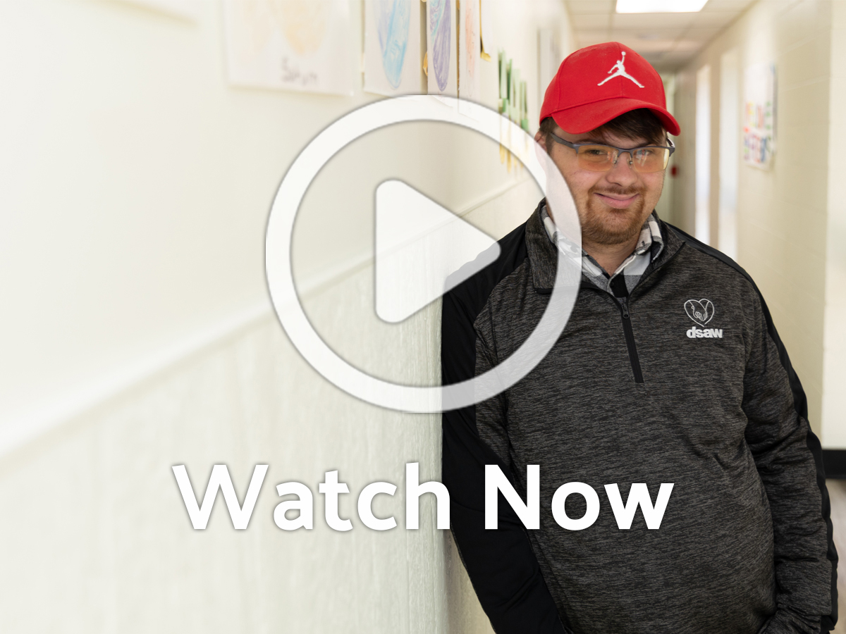 Image of person in hallway with Overlay Play Button