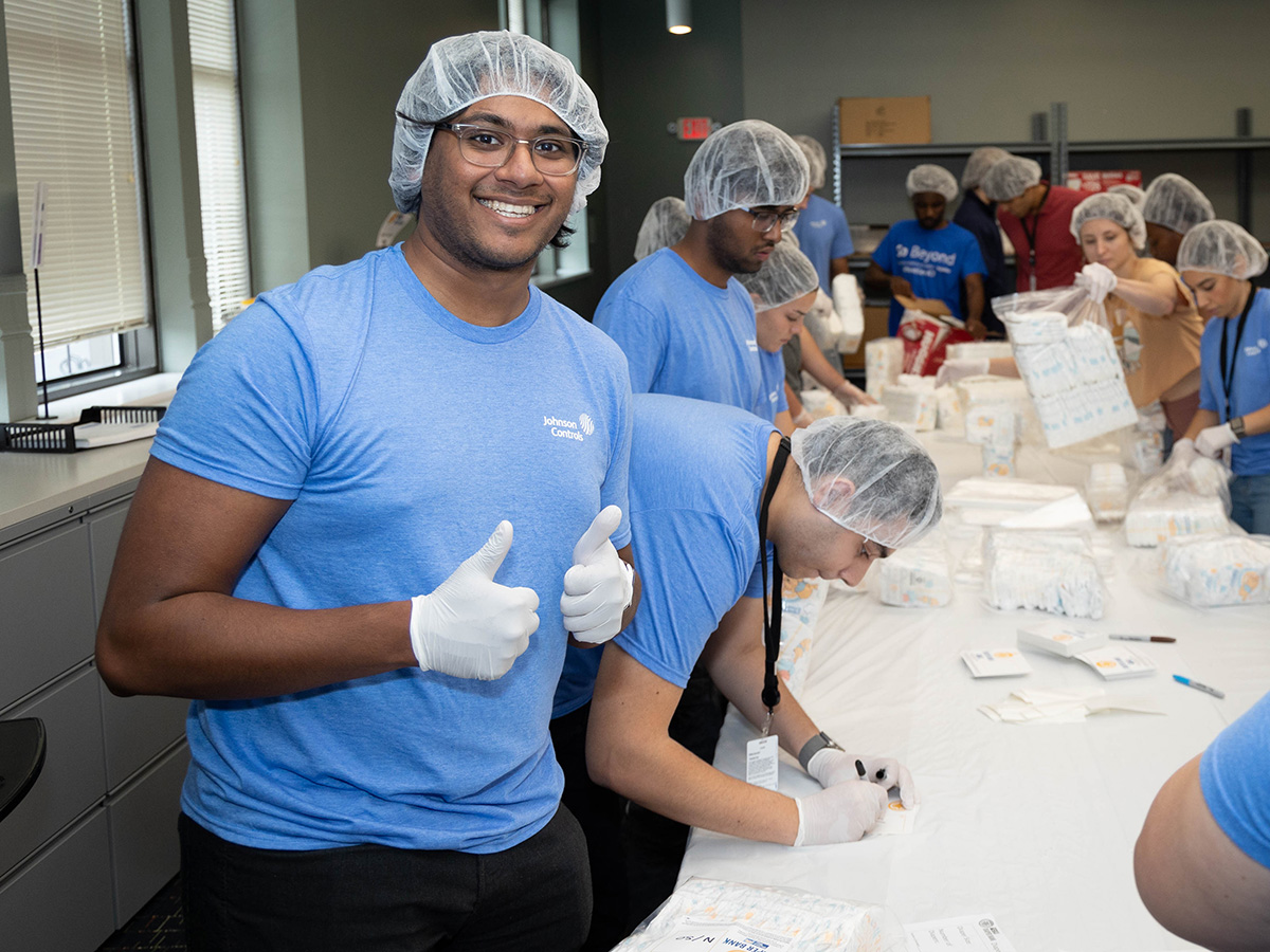 image of group in hair nets packing daipers