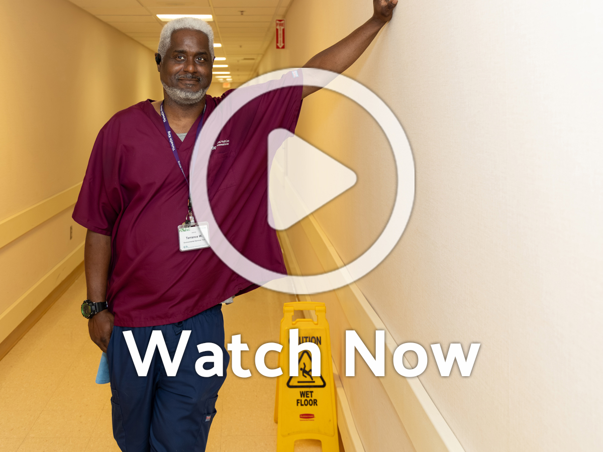 Image of person in hallway with Overlay Play Button