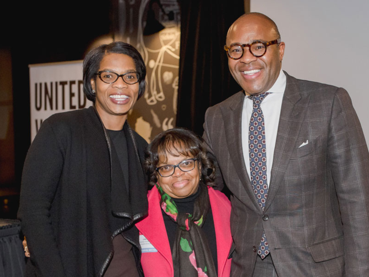Photo of three people at event