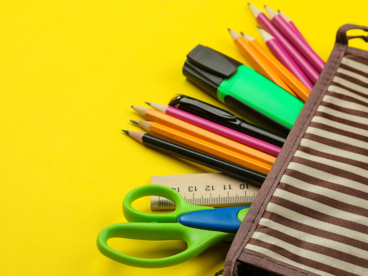Scissors, pencils, paper clips, ruler, eraser, and highlighters in a pencil pouch