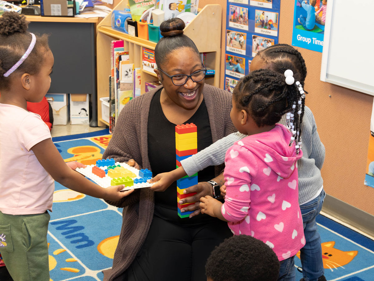 Teacher working with young students