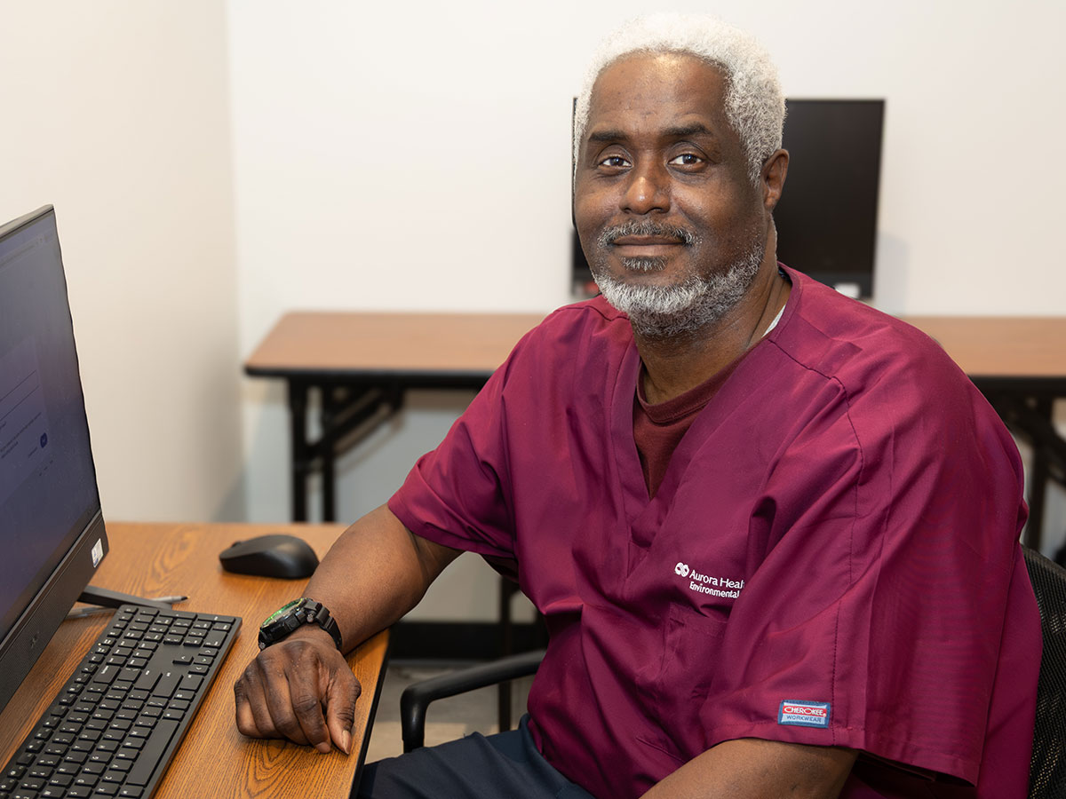 man sitting at computer