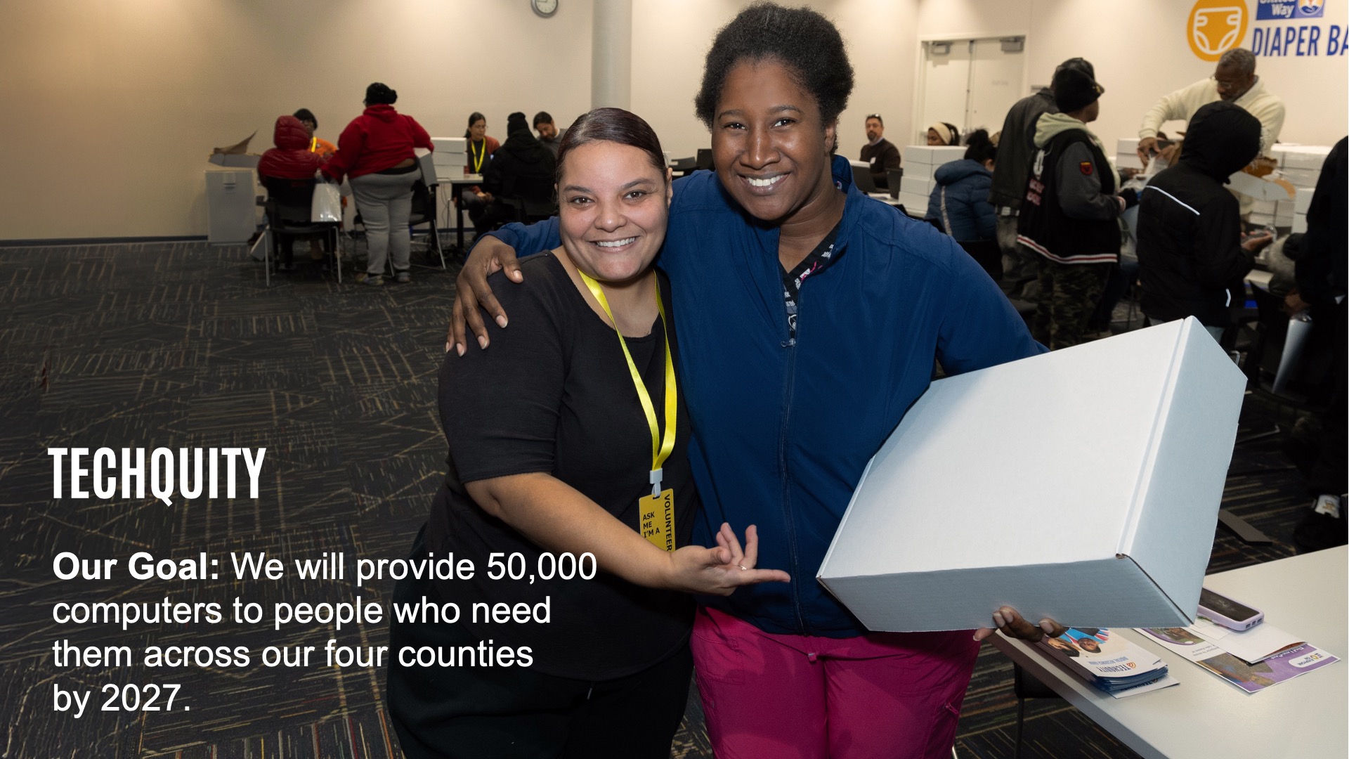 Image of Two people at Techquity Distribution Event with Techquity and Goal