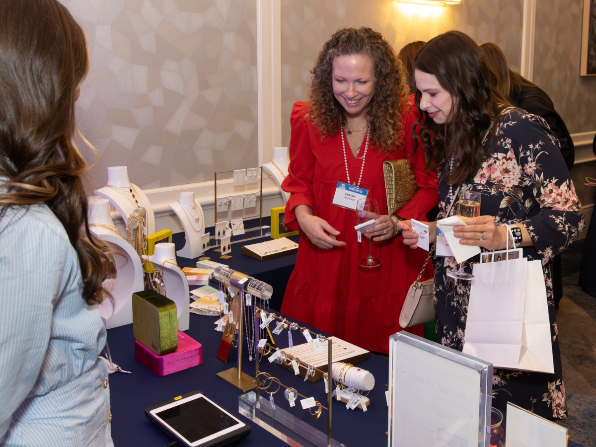 Image of women shopping with a person at a booth