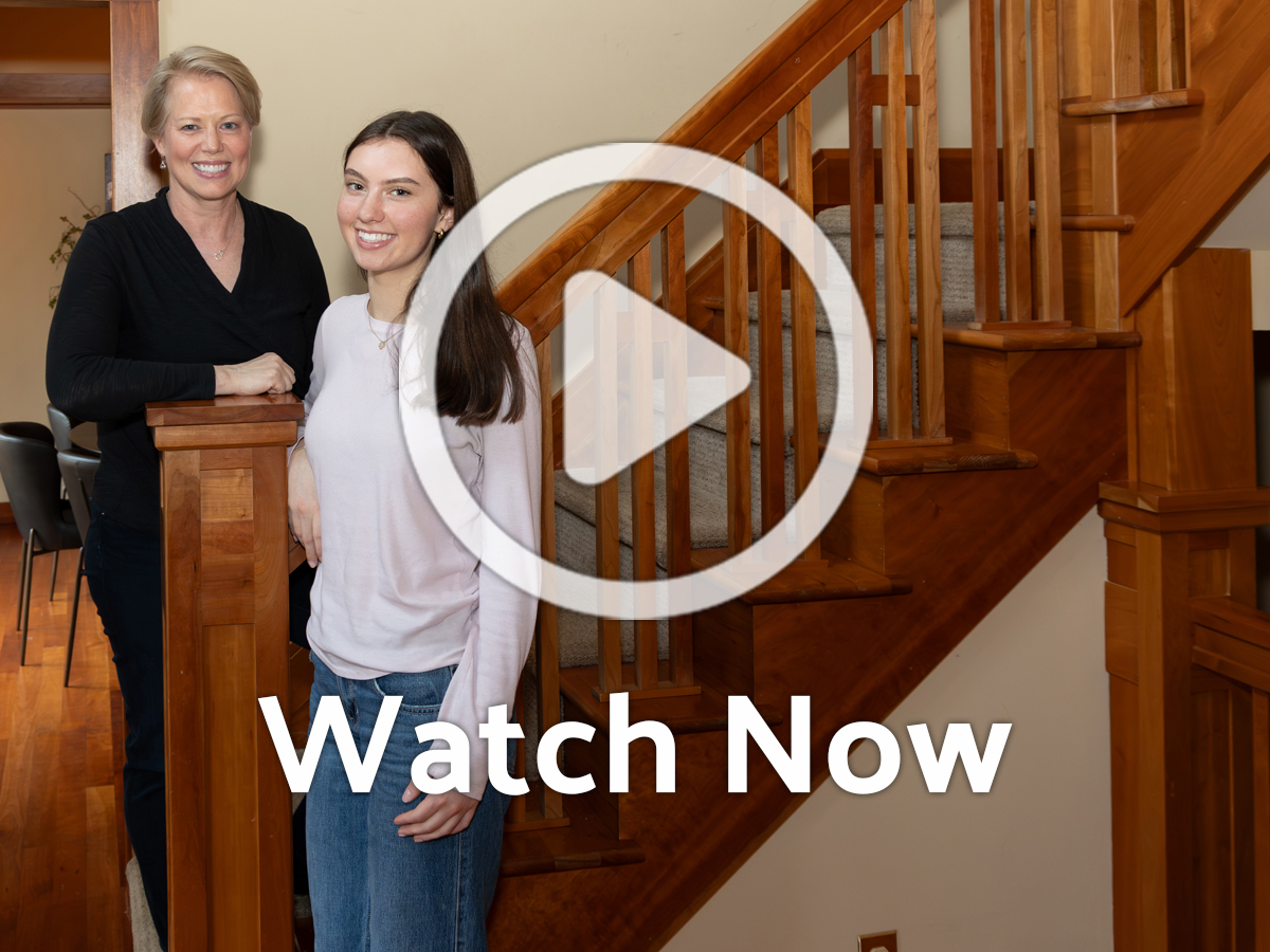 Image of mother and child by staircase with Overlay Play Button
