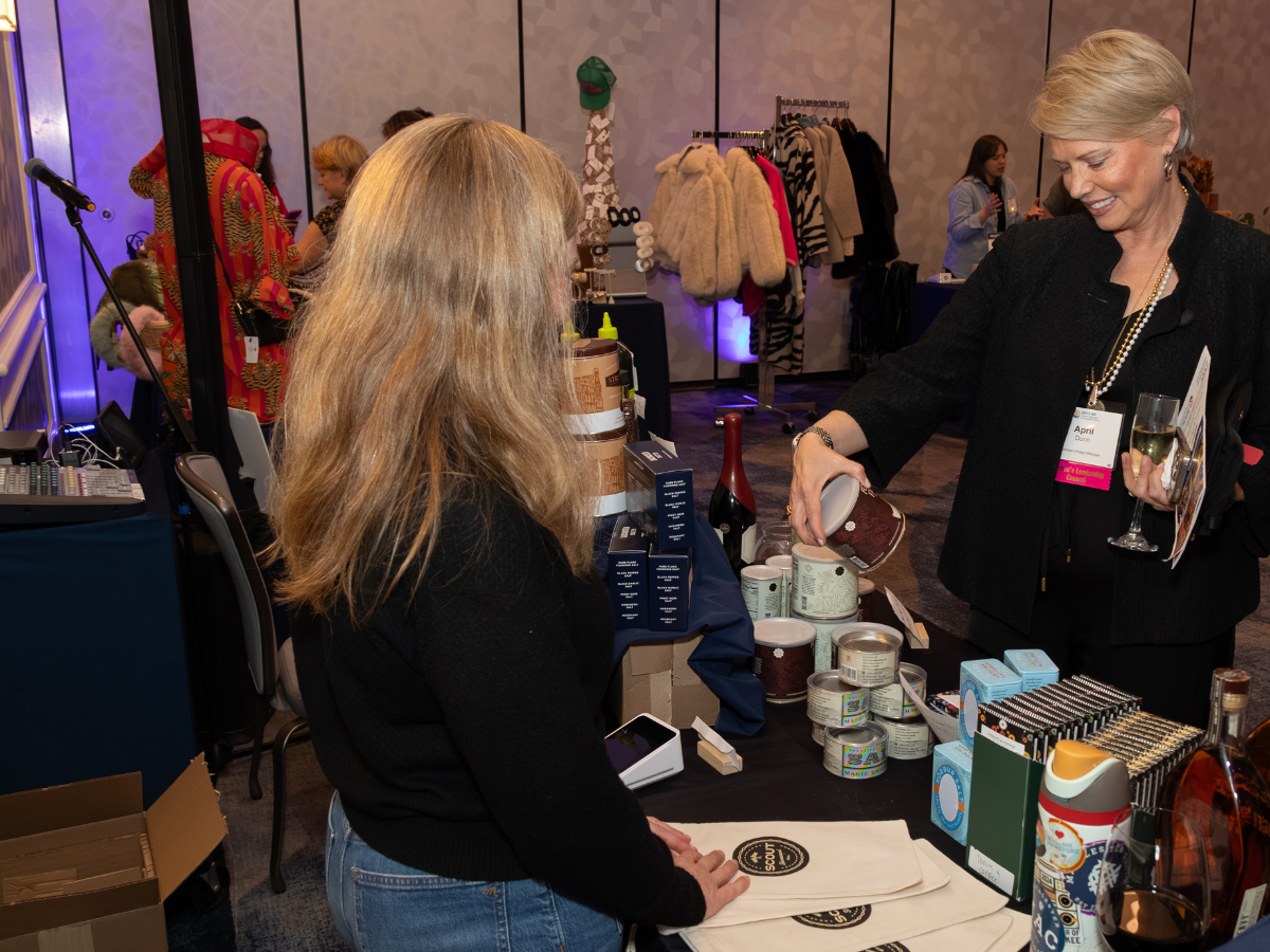Image of women shopping with a person at a booth