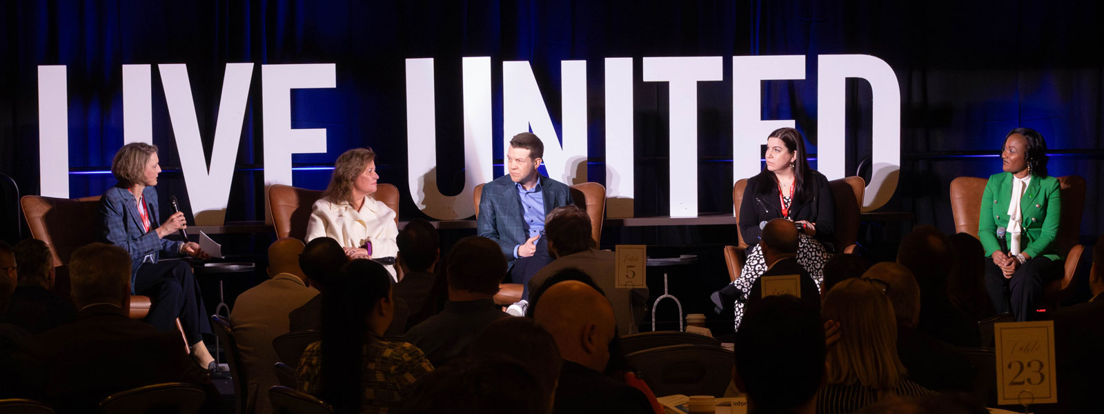 image for a panel discussion with five people on a stage