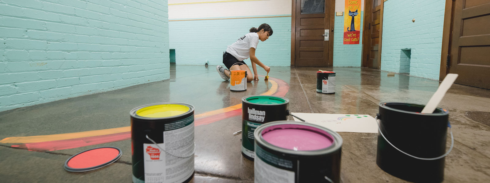 image of woman painting floor mural