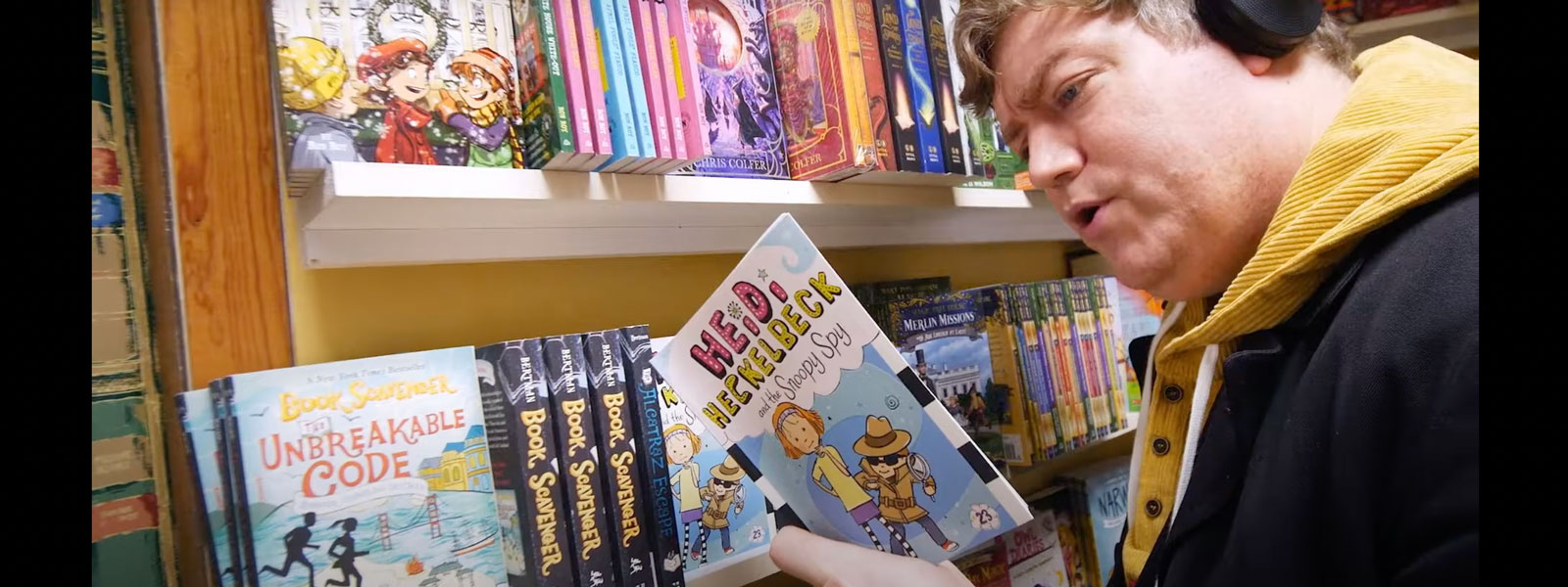 photo of man reading a children's book at a book store