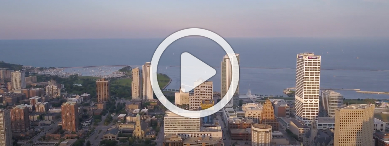 Skyline of Milwaukee with play button overlay