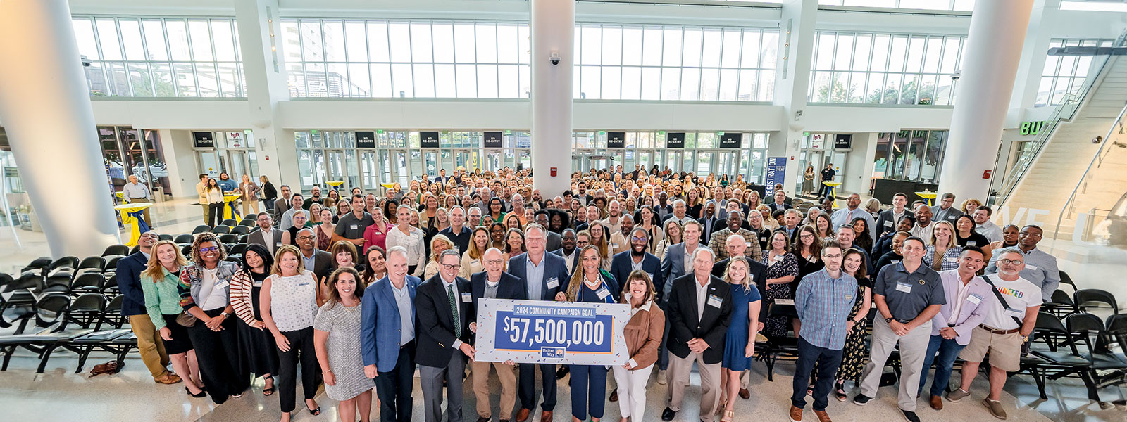 Group of people holding sign that says "2024 Community Campaign Goal $57,500,000