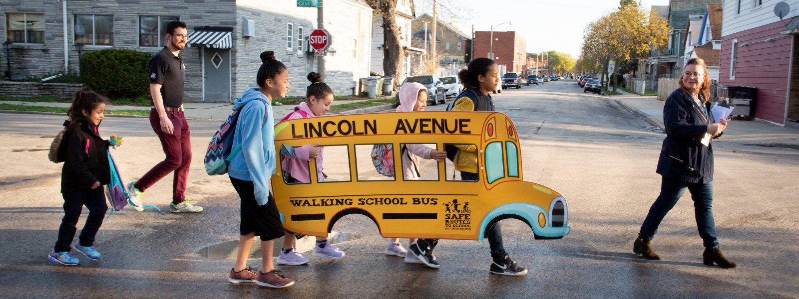 Kids crossing street with cutout school bus