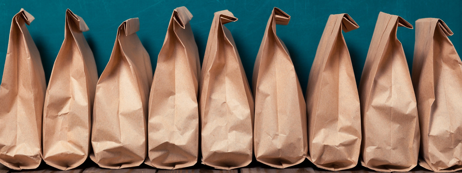Bagged lunches lined up in a row.