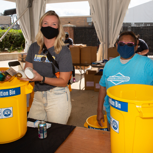Volunteers sorting donations in the yellow donation bins.