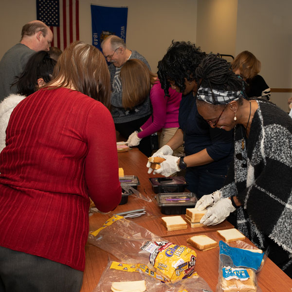 Group making sandwiches for individuals experiencing homelessness