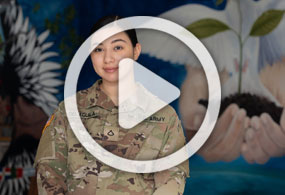 Image of young adult in uniform with video play button overlay