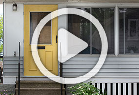 Image of house porch with button to play video