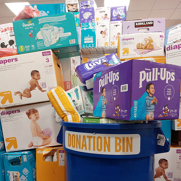 image of stack of diaper boxes by donation bin