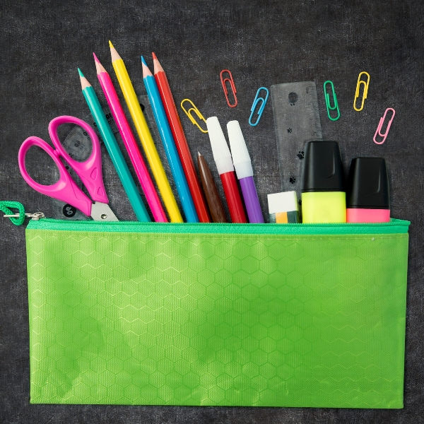 Scissors, pencils, paper clips, ruler, eraser, and highlighters in a pencil pouch