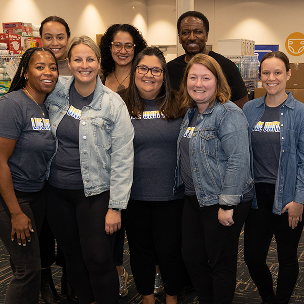 group of Rockwell employees posing for a photo while packing diapers