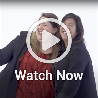 image of two women smiling with video play button overlay