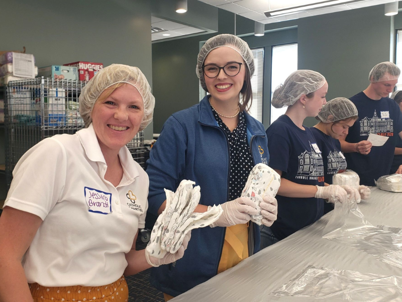 Jessica Brandt and a Catholic Charities colleague at a diper repack event